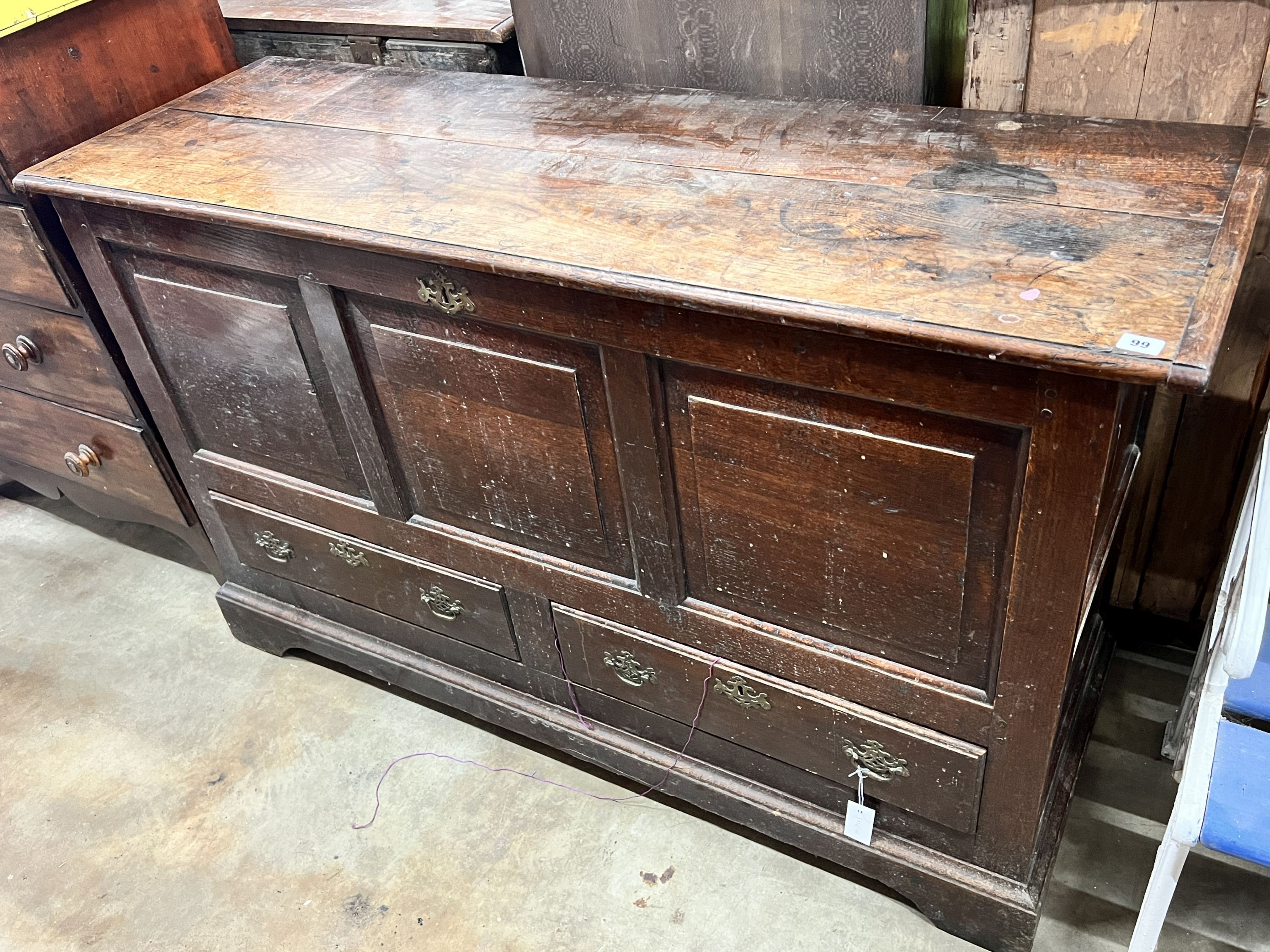 A mid 18th century oak mule chest with squared triple panelled front, width 151cm, depth 50cm, height 90cm